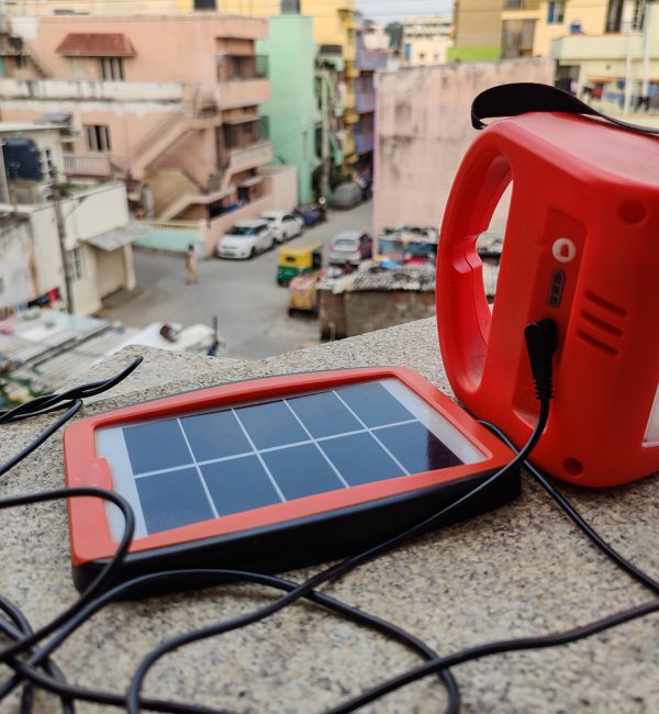 Picture of small size red color solar panel with torch or solar Picture of small size red color solar panel with torch or solar lamp